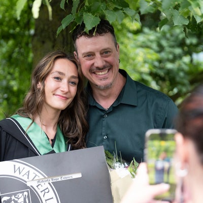 student posing with father for a picture 