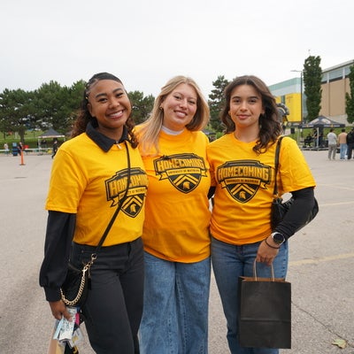 3 arts students enjoying parking lot party 