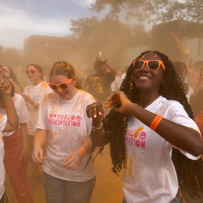 students dancing in the orange chalk throw 