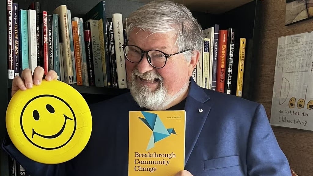 Paul Born holding up a book and smiley face