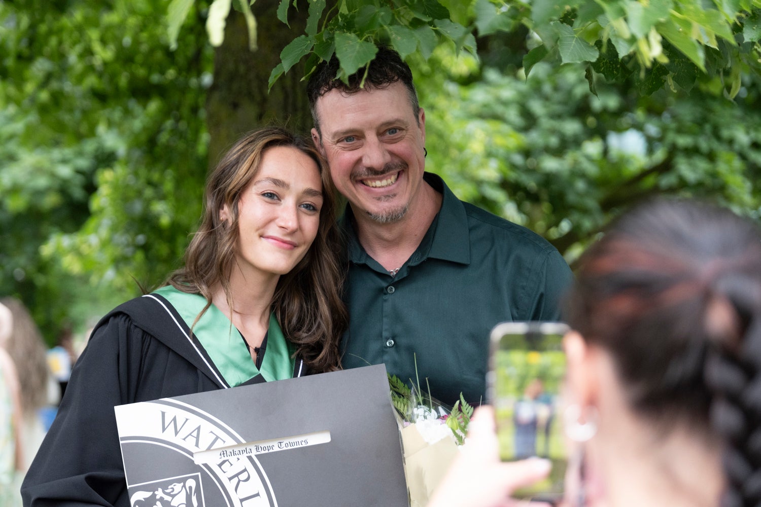 student posing with father for a picture 