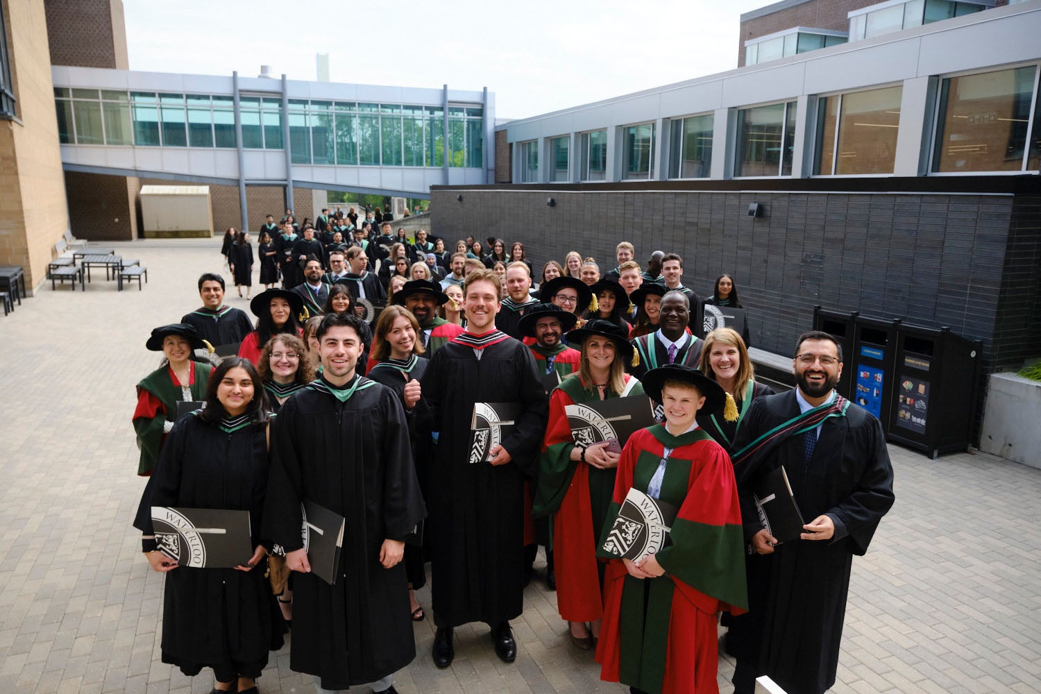 A big group of graduates gather outside the PAC