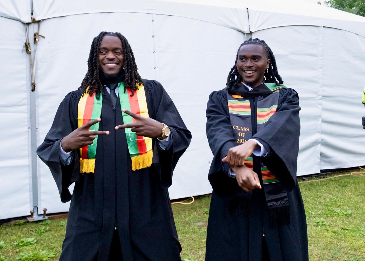 two student representing cultural apparel for convocation 