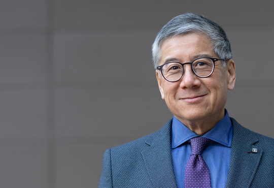 Professor Fong against a grey background