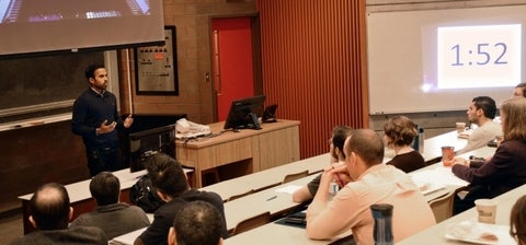 student presents to audience in lecture theatre