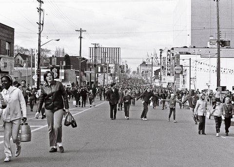 archival photo of people walking on street
