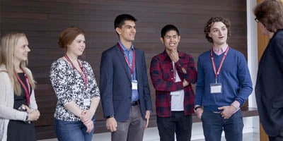 Students talk with faculty member