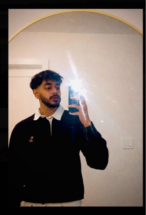 Zuhair taking a mirror selfie with the flash on