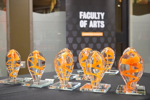 Arts awards - clear glass artwork featuring ribbons of orange colour throughout