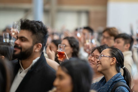 People in Hagey Hall raising their glasses to toast