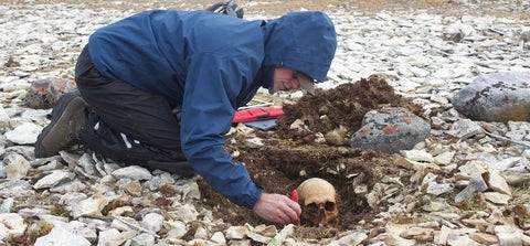 Douglas Stenton excavating human skull