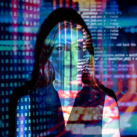Data and code projected onto a woman