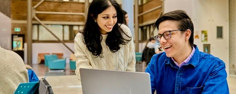 two students at work with laptop