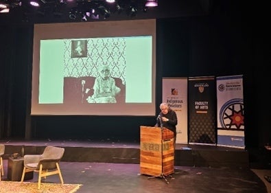 Greg Staats at the podium in the Theatre of the Arts