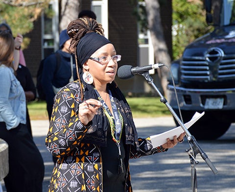 Laura Mae Lindo speaks at an event in the Arts Quad, 