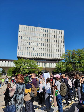 A crowd of people in the Arts Quad in front of the Dana Porter library