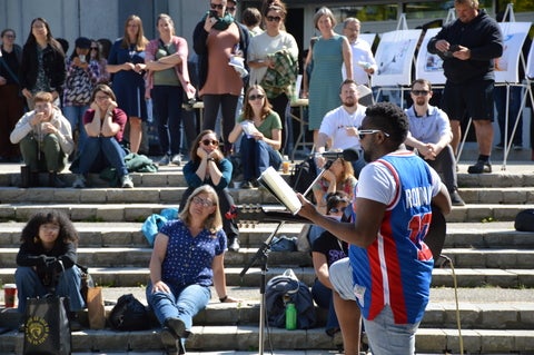 Black man playing guitar in front of audience