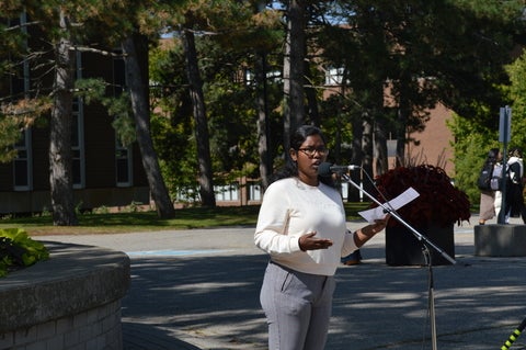 Woman of colour speaking at mic