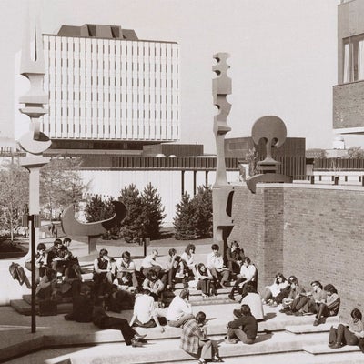 Sepia photo of groups of students sitting in the Hagey Hall courtyard