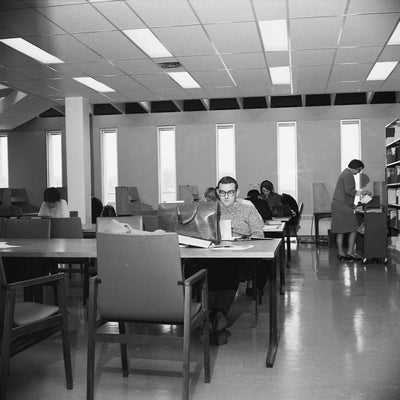 Black and white photo of a student at a desk in DP