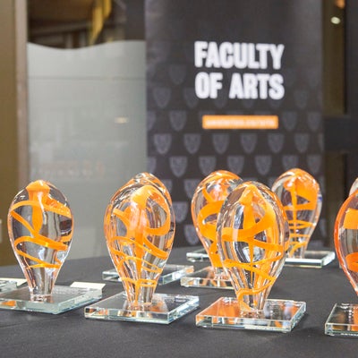 Arts awards - clear glass artwork featuring ribbons of orange colour throughout