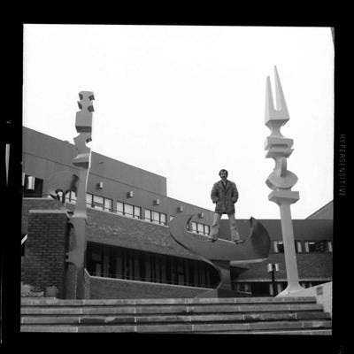 Archival photo of man standing on top of the sculpture