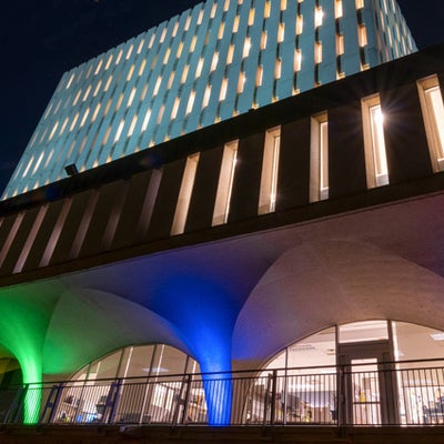 The arches of the Dana Porter Library light up with coloured lights arranged in a rainbow