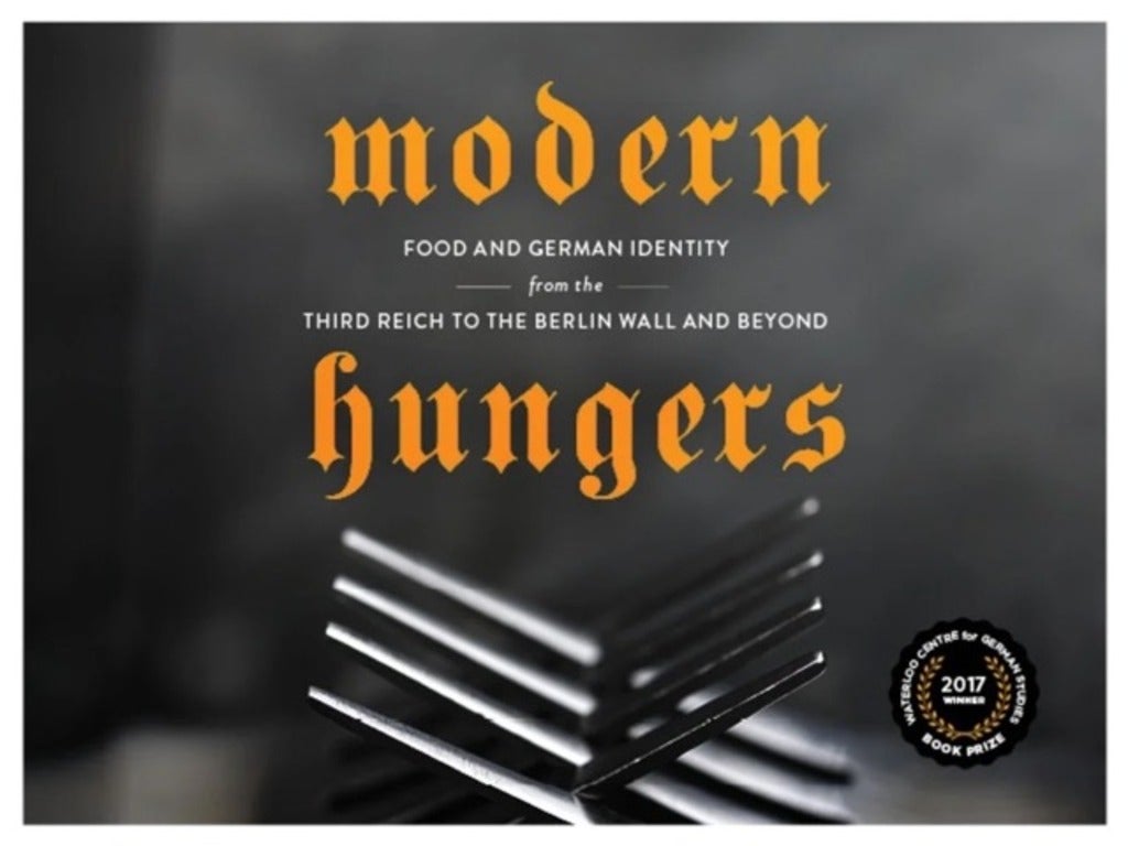Banner that says "moden hungers" with two intertwined forks. Logo to show it won a book prize