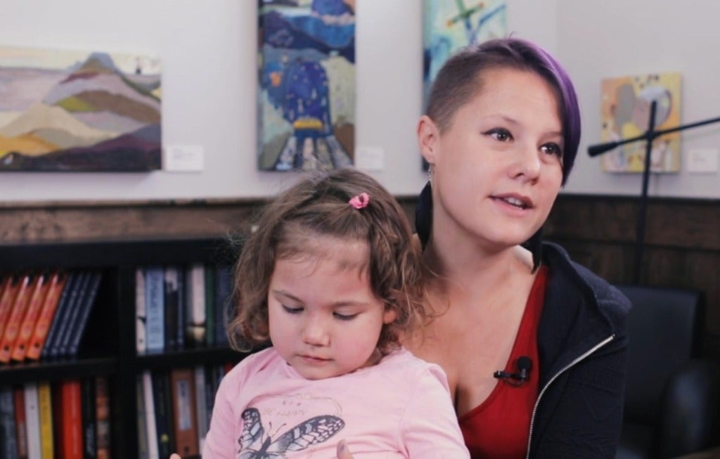 Heather George speaking with child on her lap