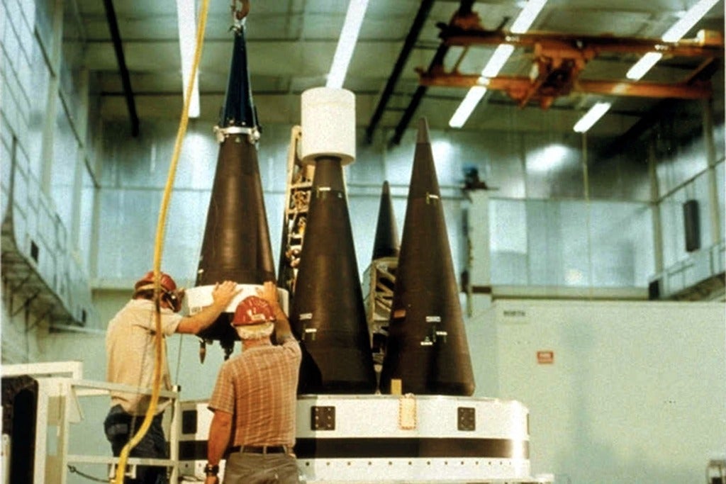 Two workers working with nuclear weapons
