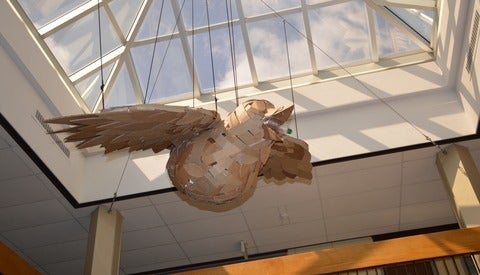 cardboard 3D bird suspended in atrium