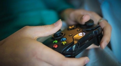 Close up of hands on a video game remote