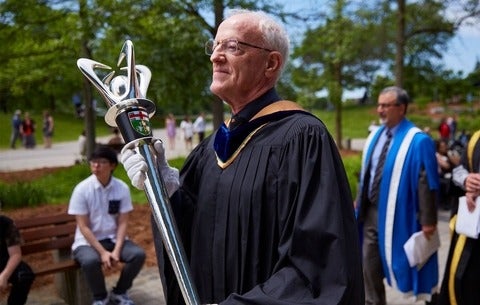 John North carrying the University mace in a convocation procession