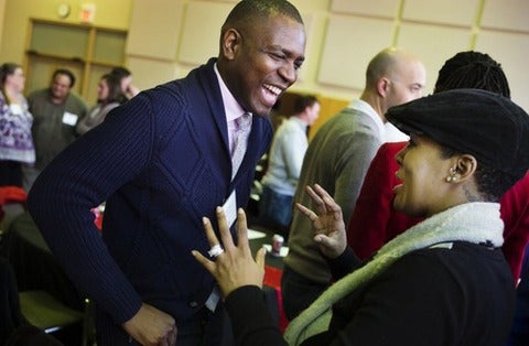 Vershawn Young speaking with person at gathering