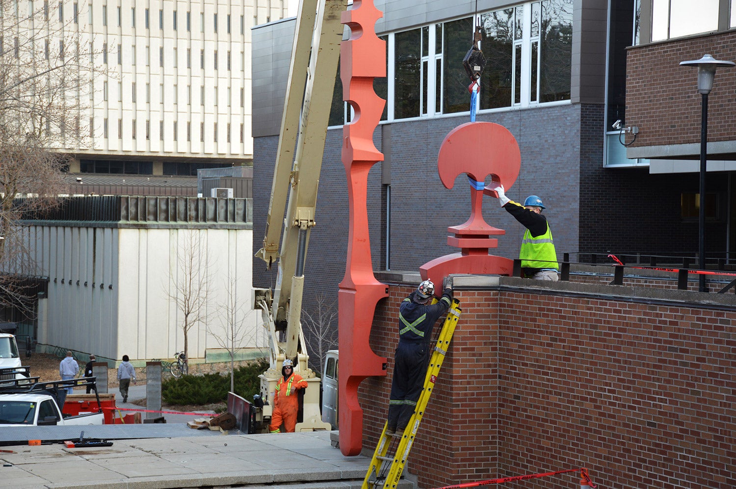 construction workers detach the sculpture from the wall