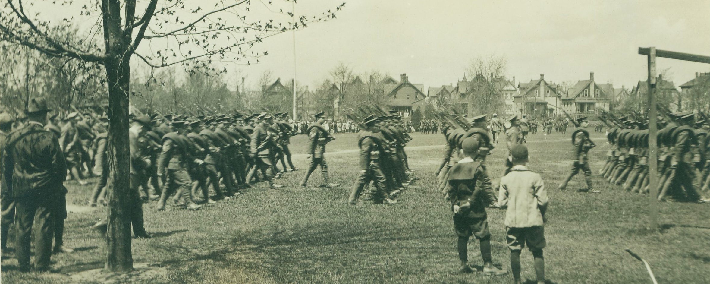 Archival image of Berlin, Ontario with soldiers marching park