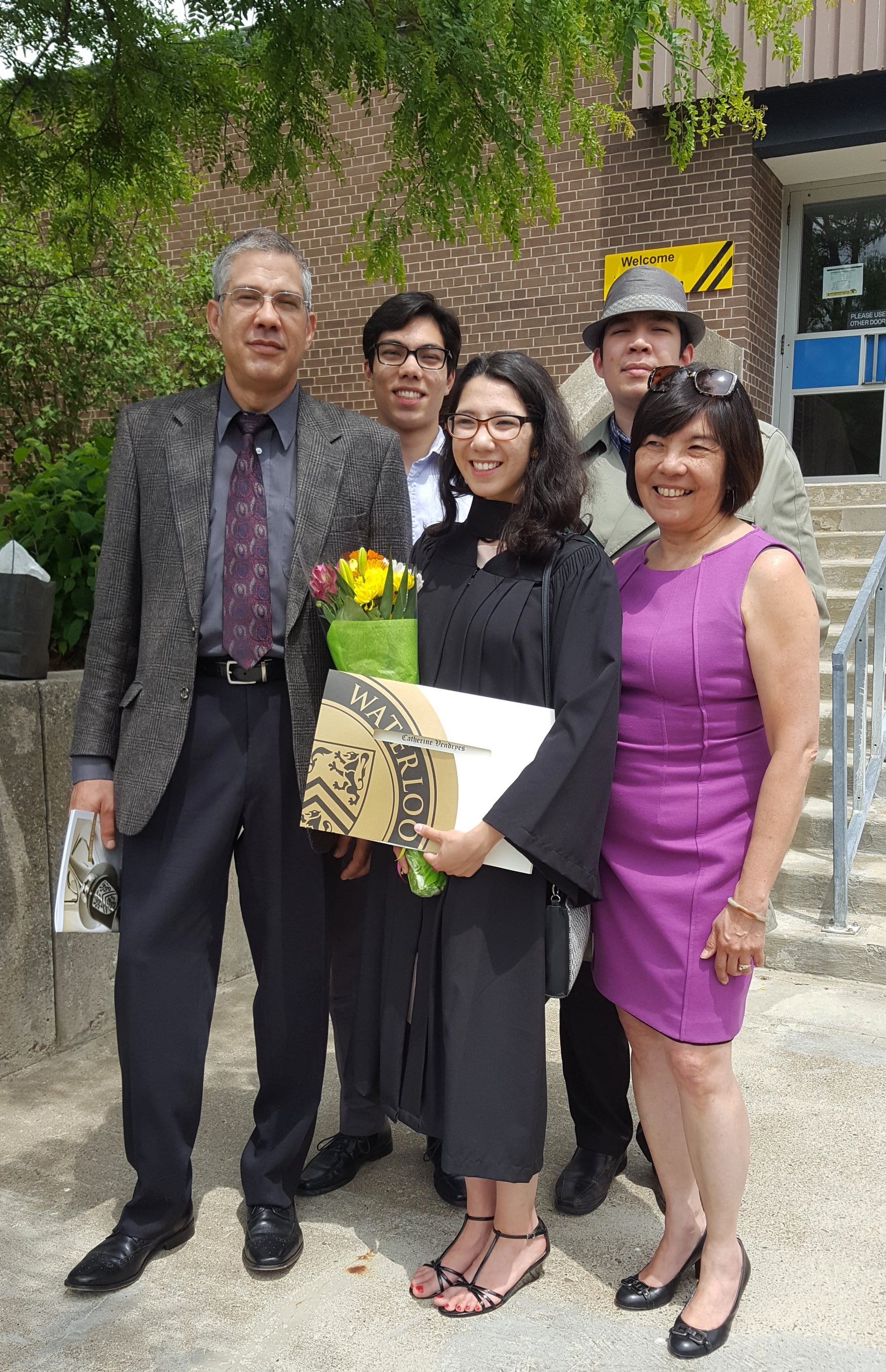 Catherine in graduation robes with her smiling family