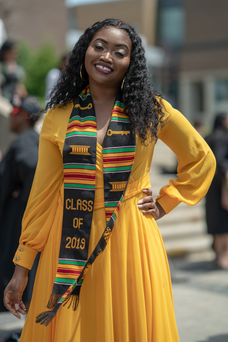 Young woman wearing brightly coloured sash that says "Class of 2019"
