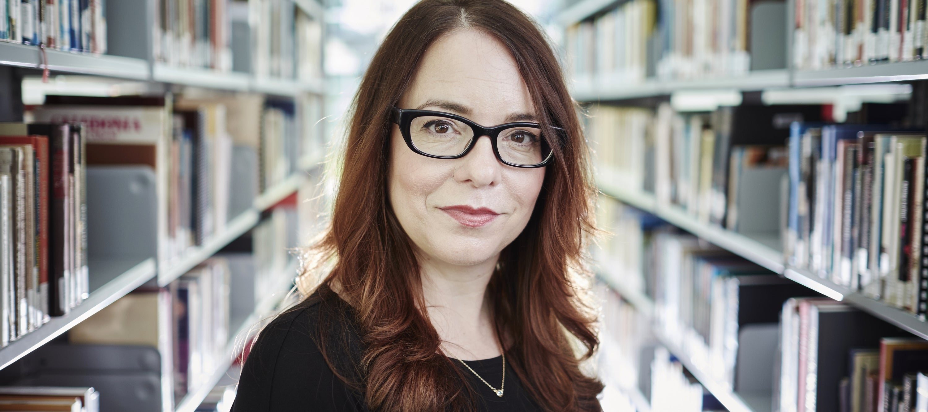 Prof Greta Kroeker in library stacks