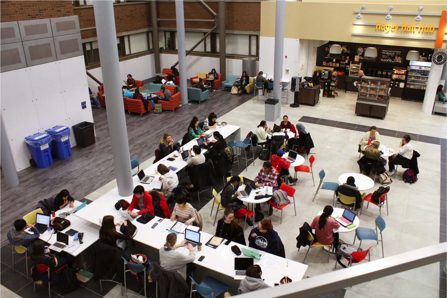 students sitting at counters and tables in hub main floor