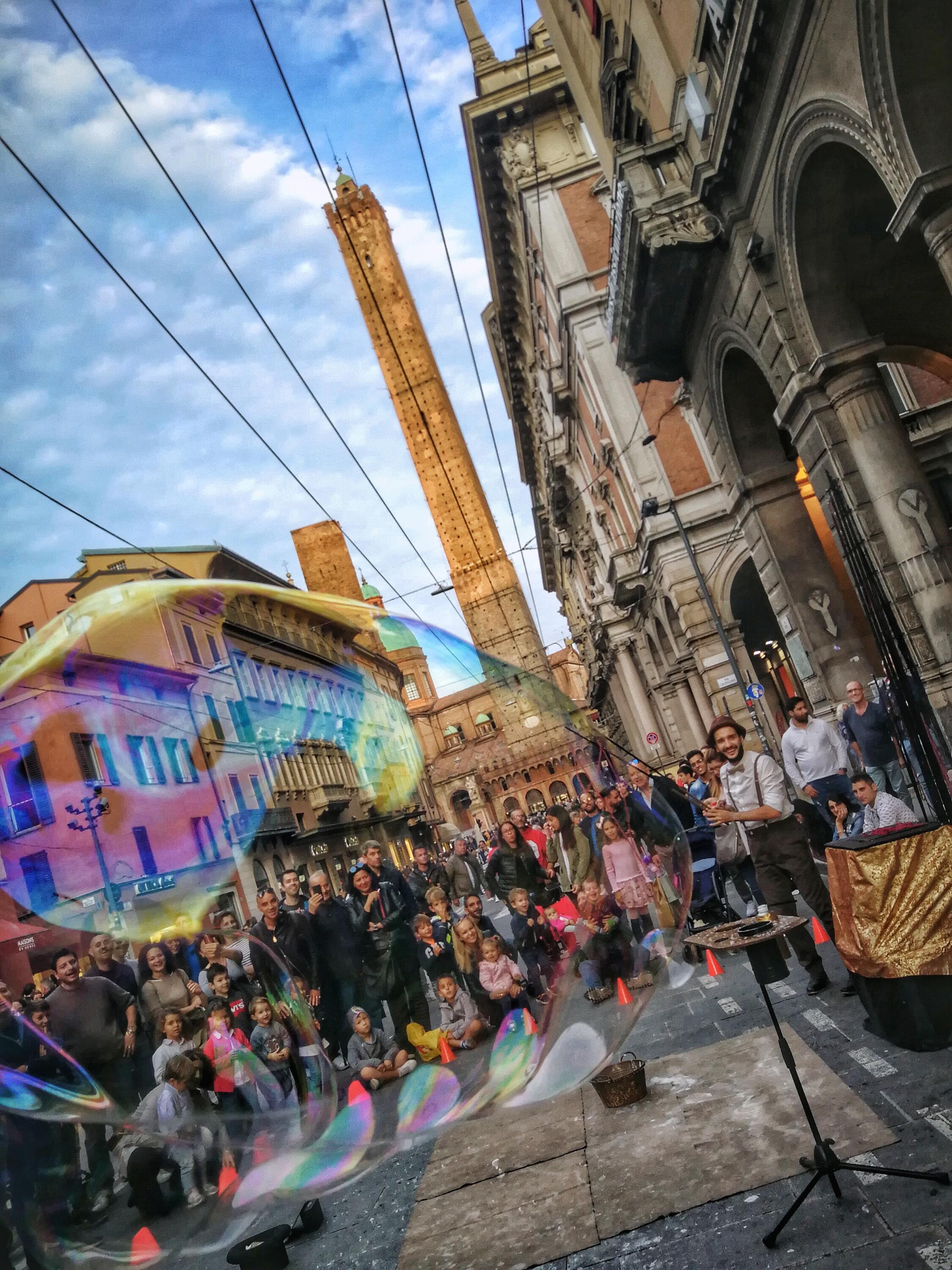 Buskers performs for crowd in Bologna street