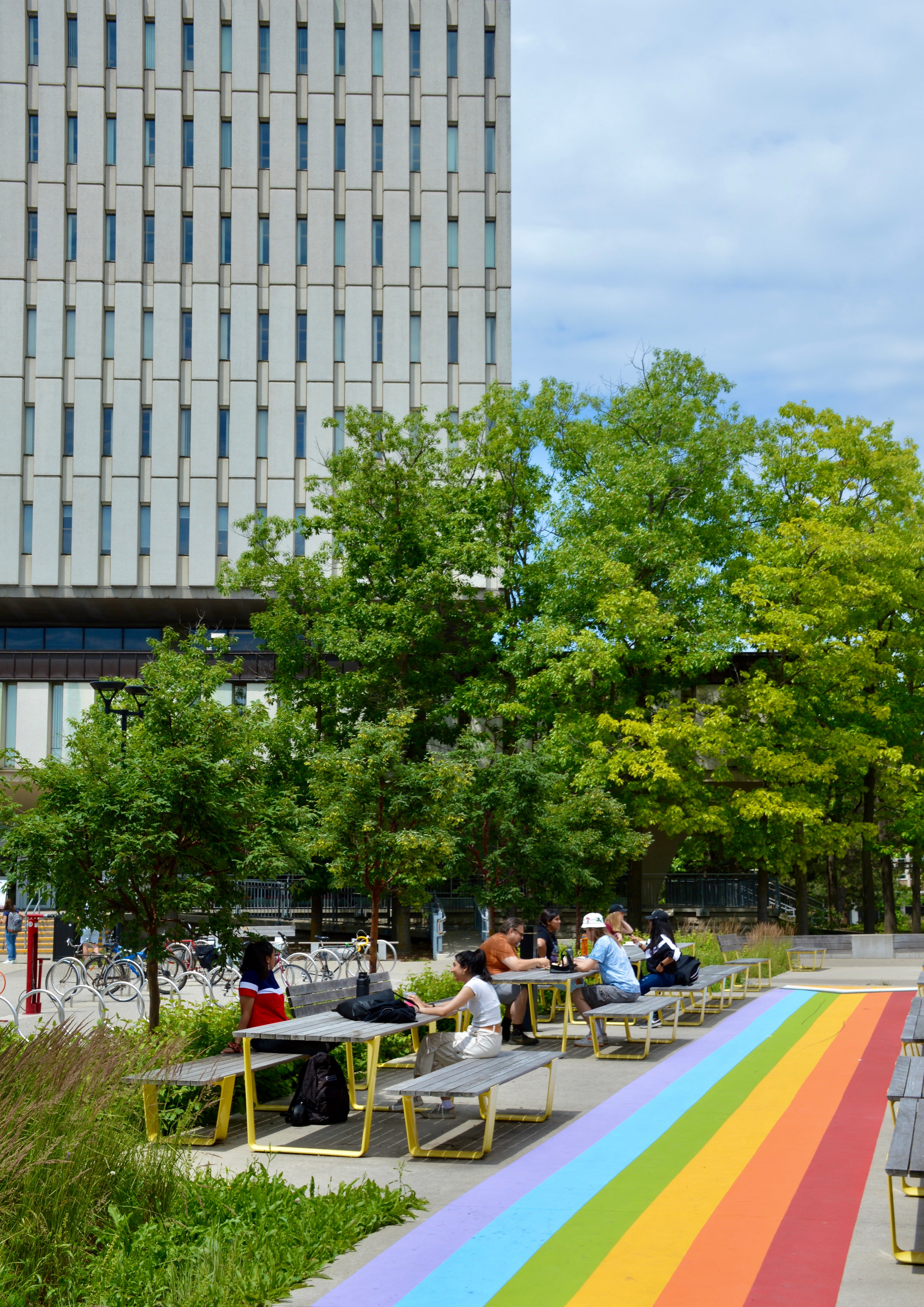 Rainbow path and with students working at picnic tables