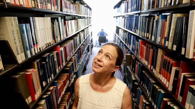 Katherien Acheson between library stacks