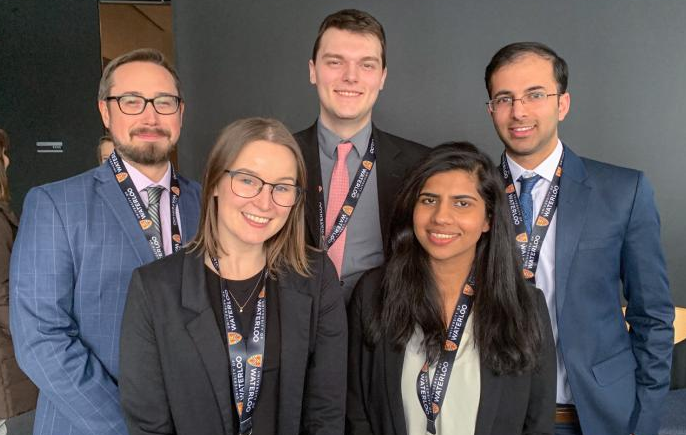 five-member Datafest grad student team smile in group pose