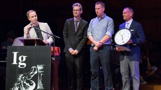 four men stand on stage at podium for Ig Nobel prize ceremony
