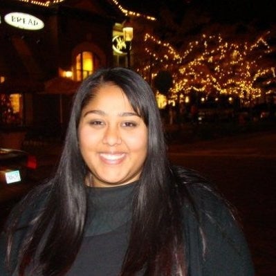 nazneen smiling with christmas lights in background