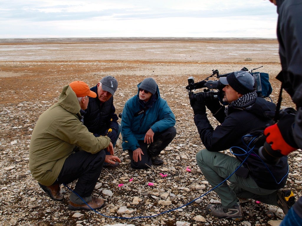 men being filmed by camera man on arctic tundra