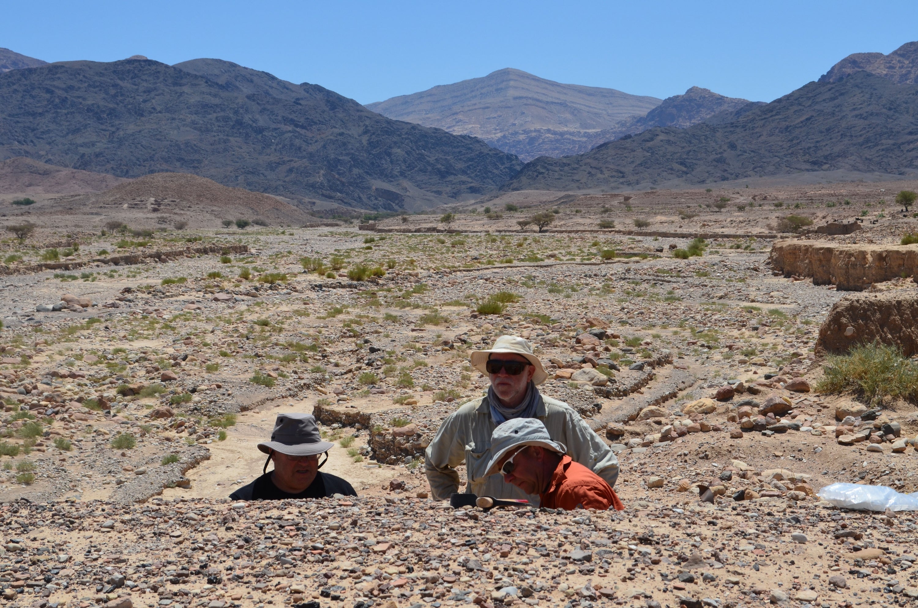 Dr. Russell Adams, Professor David Gilbertson and Dr. Keith Haylock examing upper sections at Tell Wadi Faynan. 