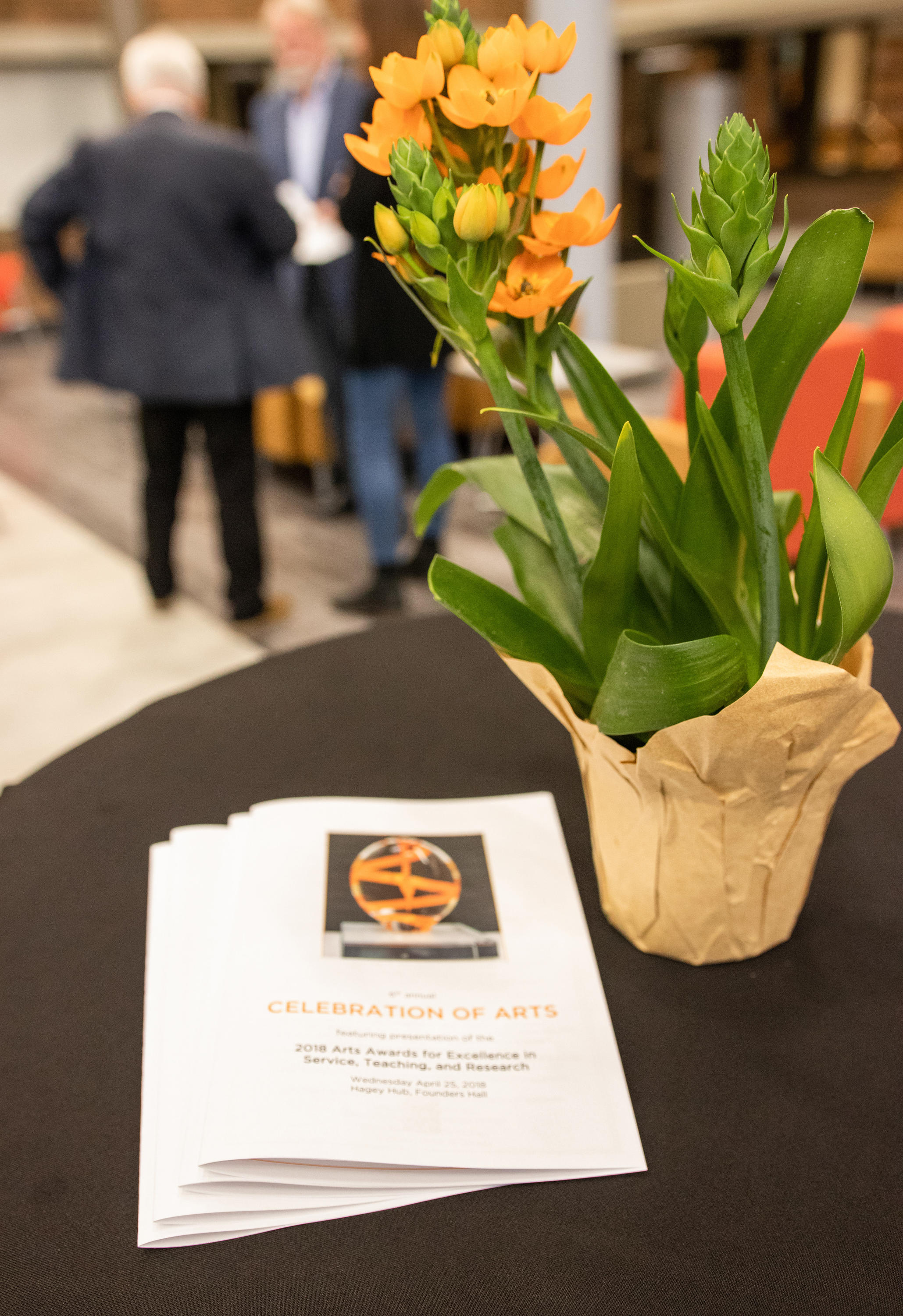 program and flowers on table