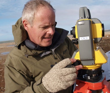 Robert Park with surveying instruments in high arctic